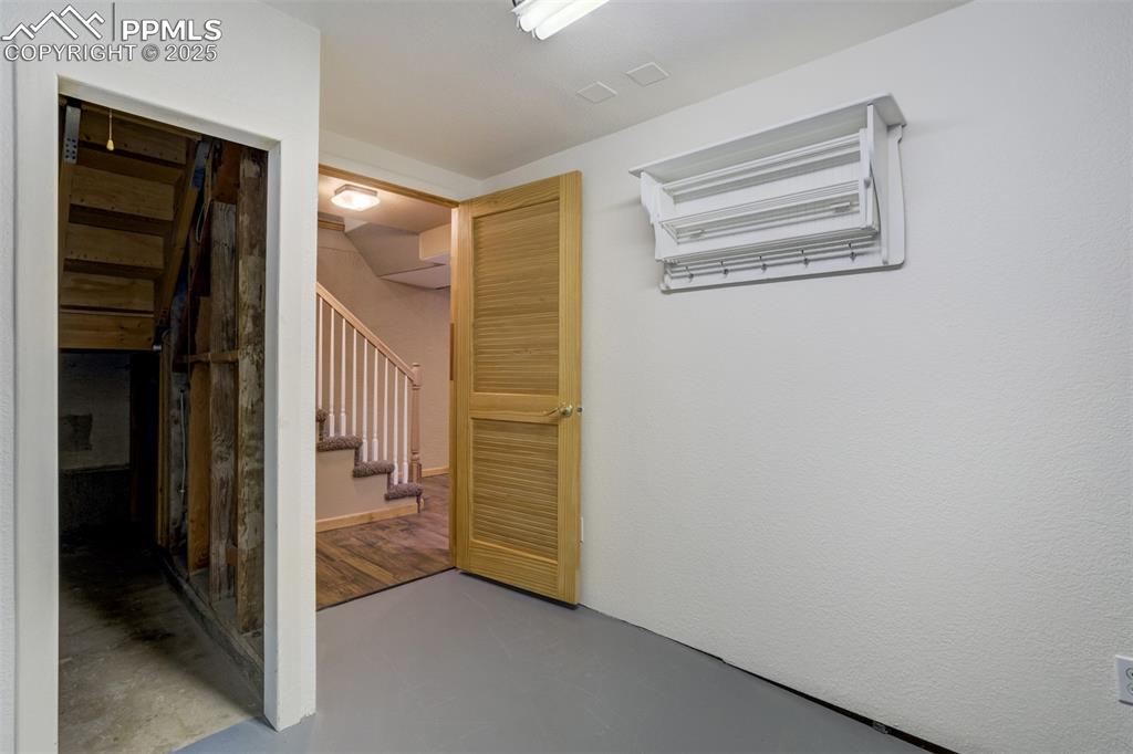 Image 32 of 50: Laundry room with under stairs storage