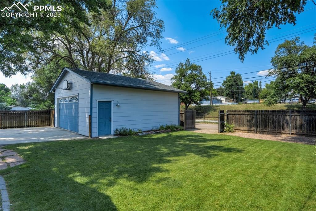 Image 48 of 50: Backyard with gate access to the alley and Rock Island Trail