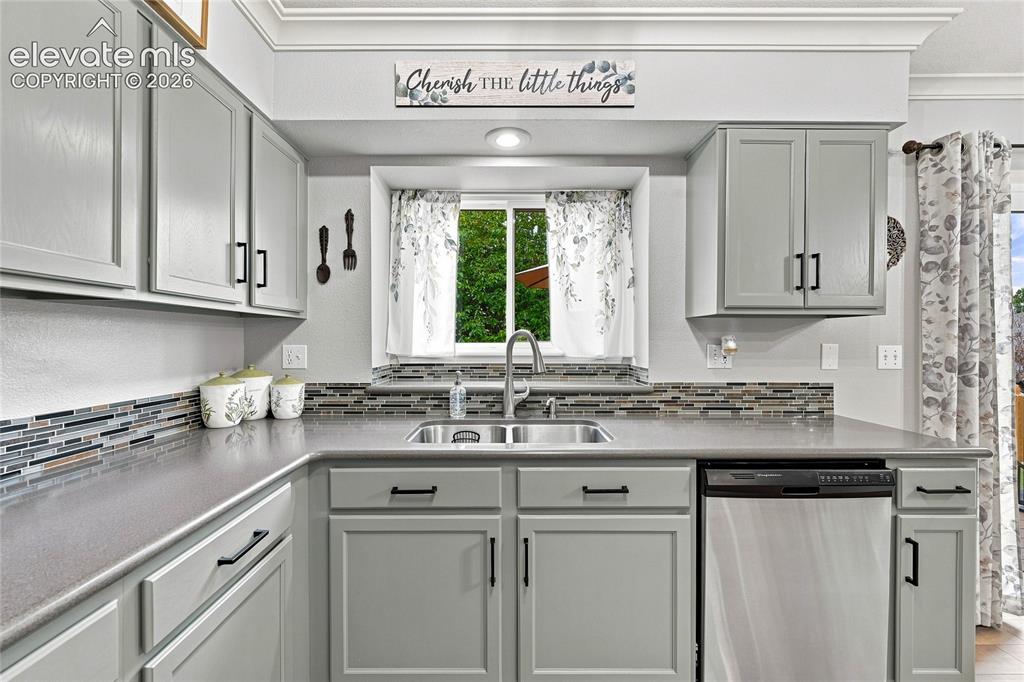 Image 14 of 45: Kitchen sink with a window