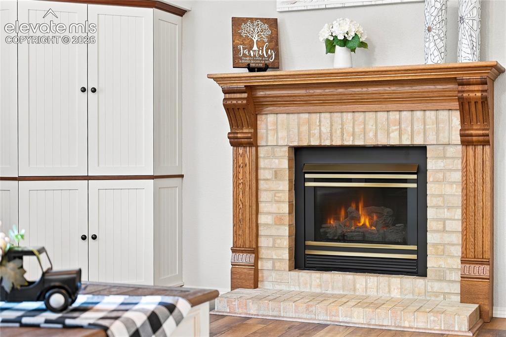 Image 20 of 45: Gas fireplace with wood mantel
