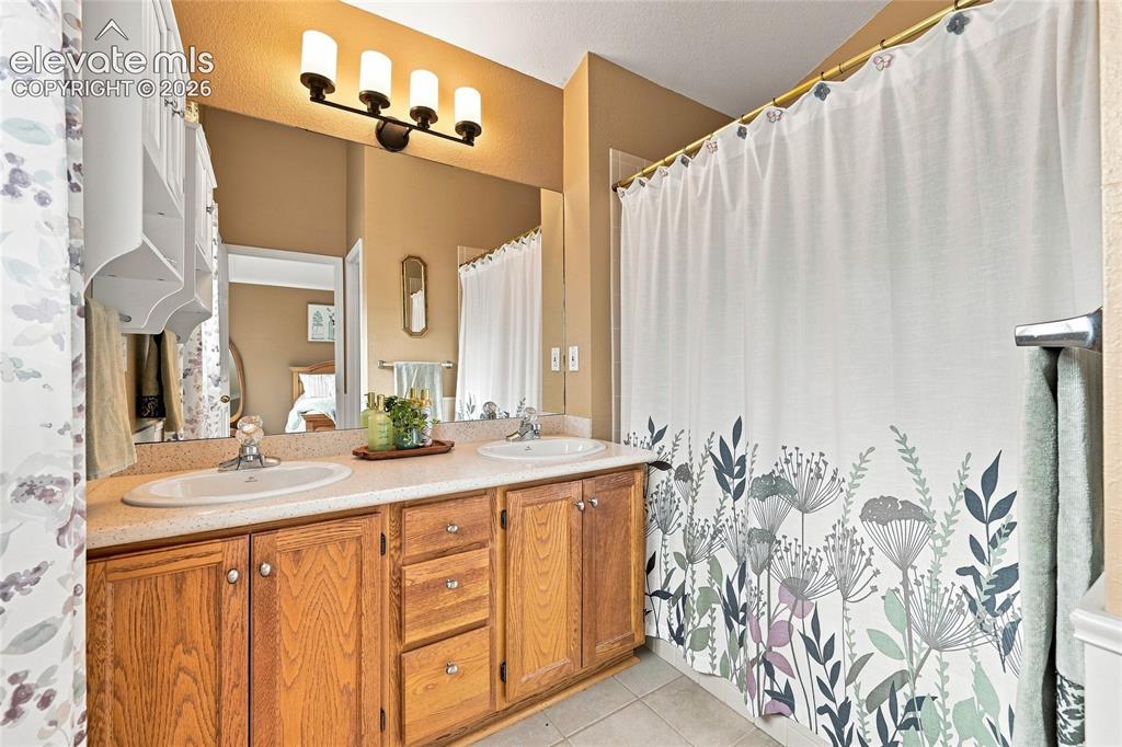 Image 26 of 45: Primary Bathroom - double sinks and full bath