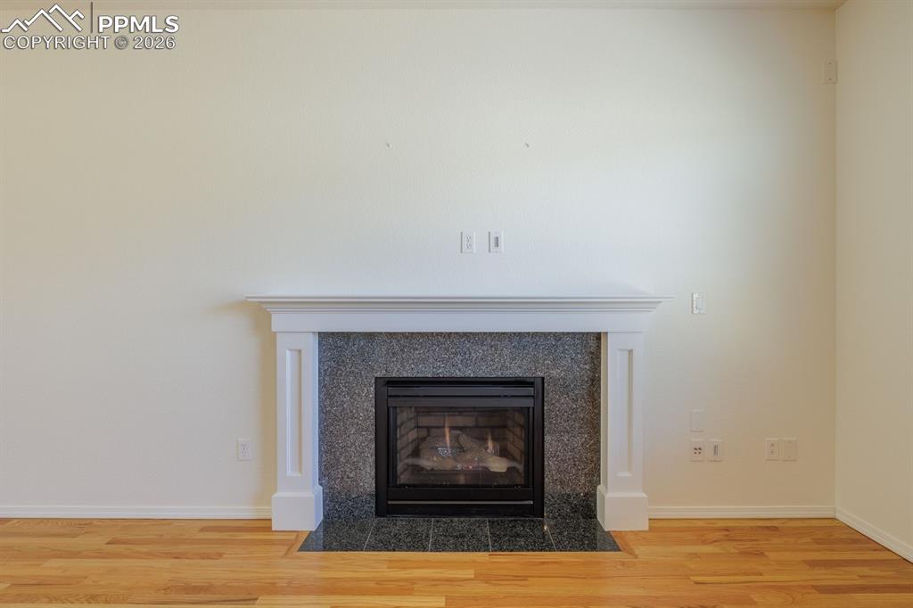 Image 15 of 50: Room featuring light blue walls, wood-finish flooring, and white baseboards