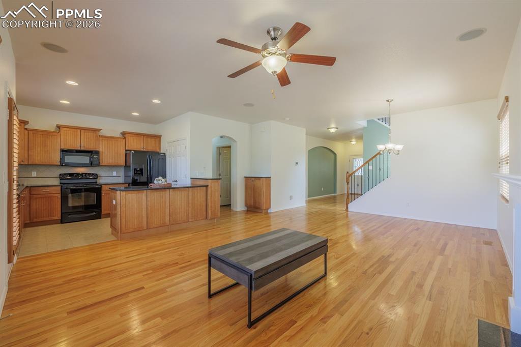 Image 17 of 50: Room with light blue walls and wood-finish flooring
