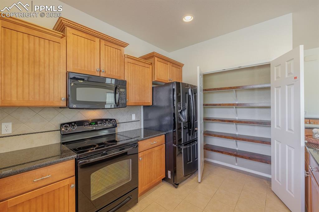 Image 20 of 50: Open concept living area featuring wood-finish flooring, a contemporary cha