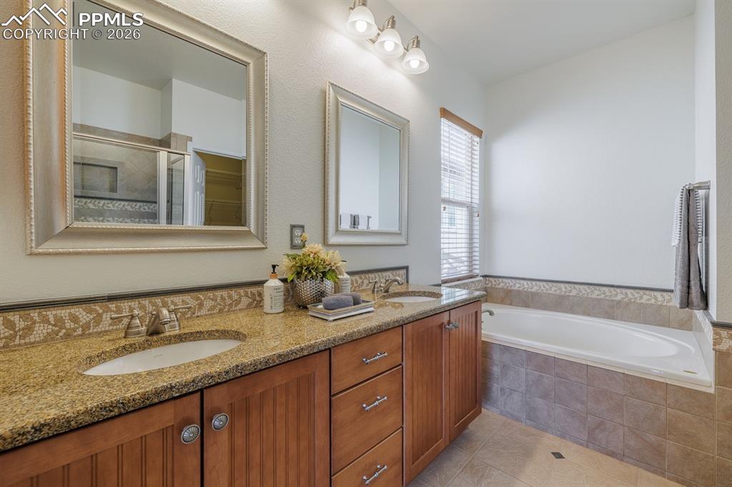 Image 25 of 50: Open-concept living area featuring wood-finish flooring throughout, a kitch