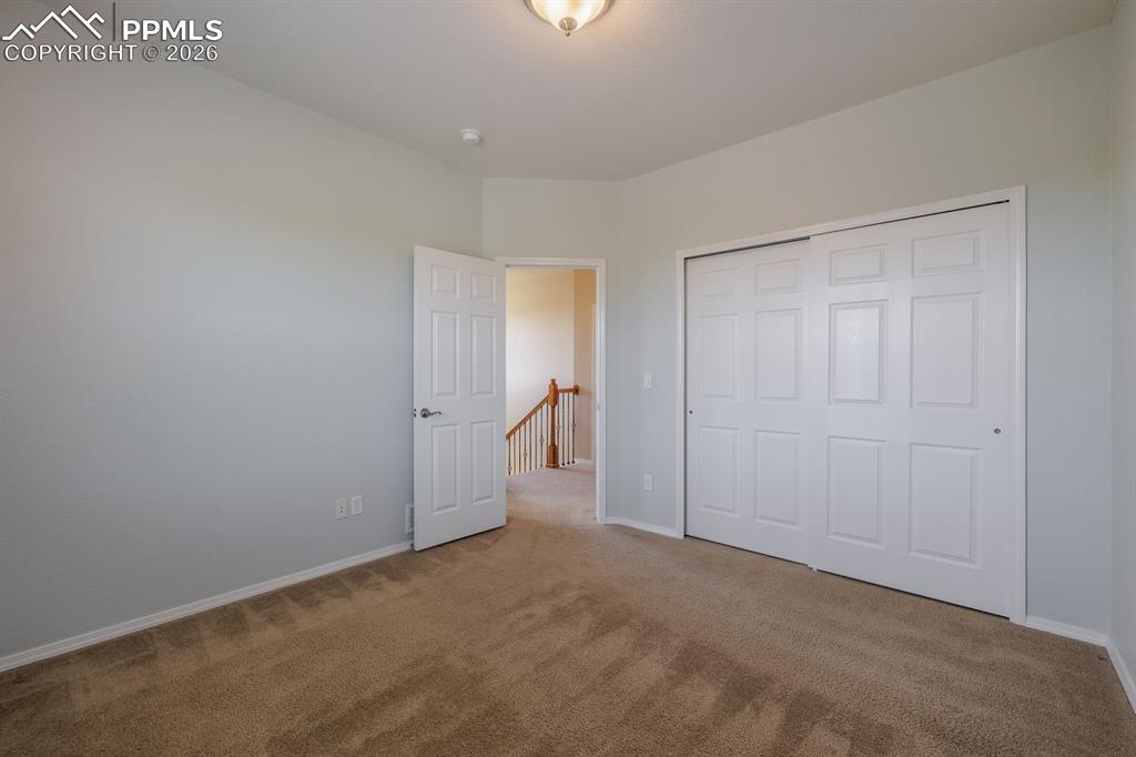 Image 30 of 50: Utility room featuring tiled flooring, a paneled door, neutral wall paint,