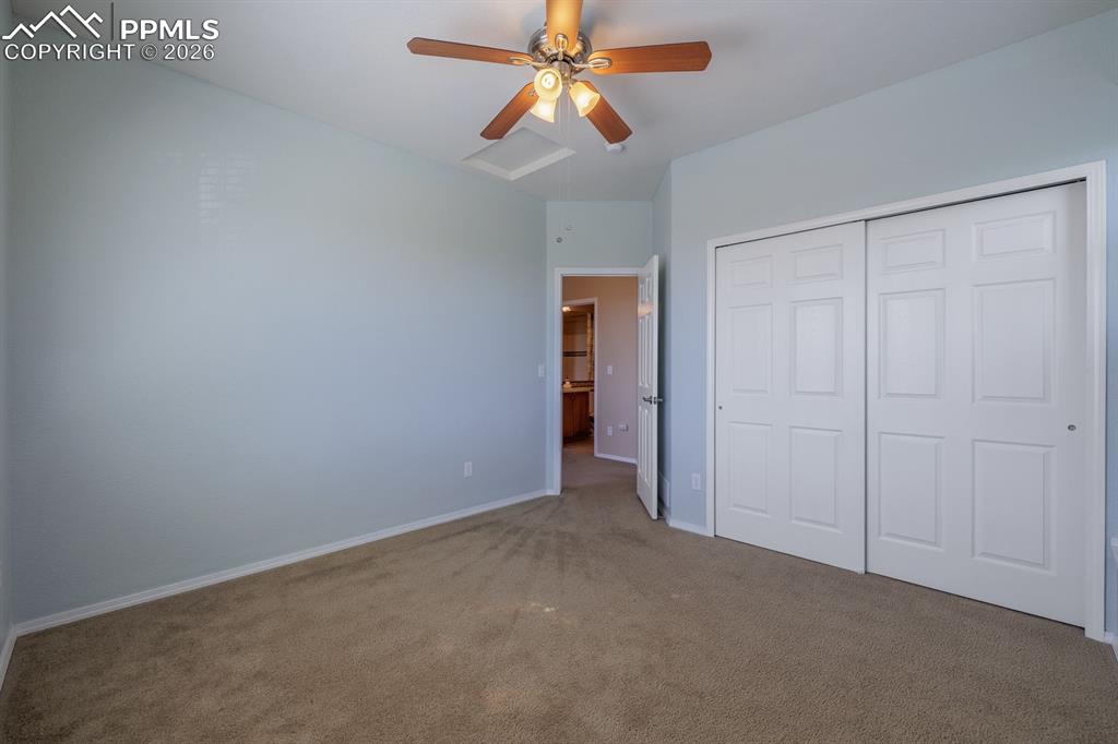 Image 32 of 50: Hardwood flooring extending through the room, ceiling fan with light fixtur