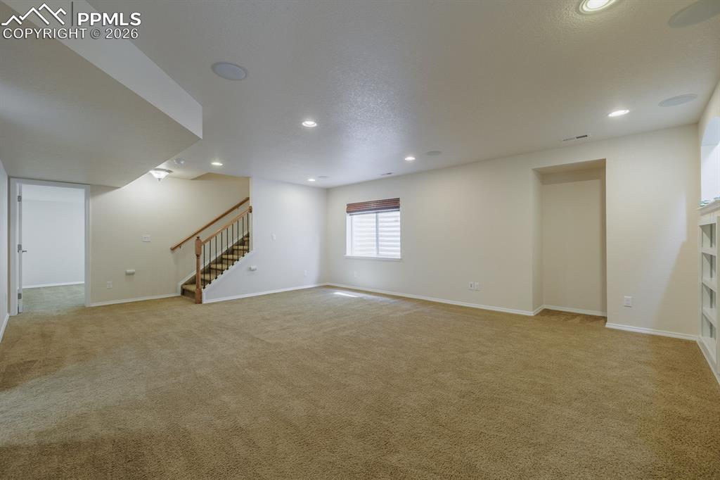 Image 37 of 50: Neutral-toned carpeting paired with light grey walls