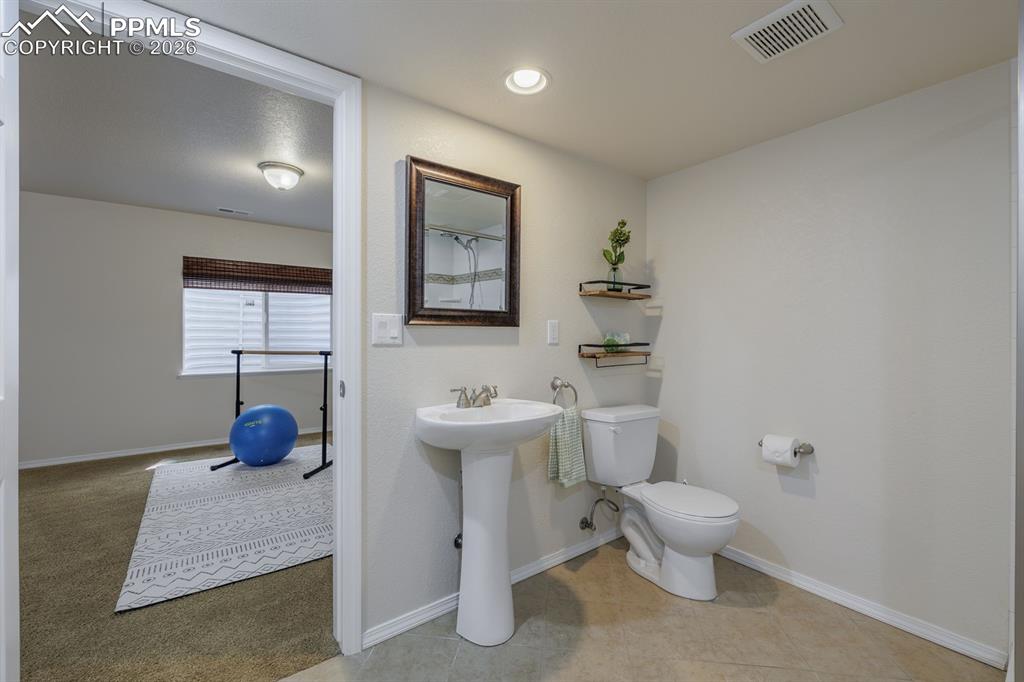Image 40 of 50: Carpeted room featuring a ceiling fan with integrated lighting, light blue