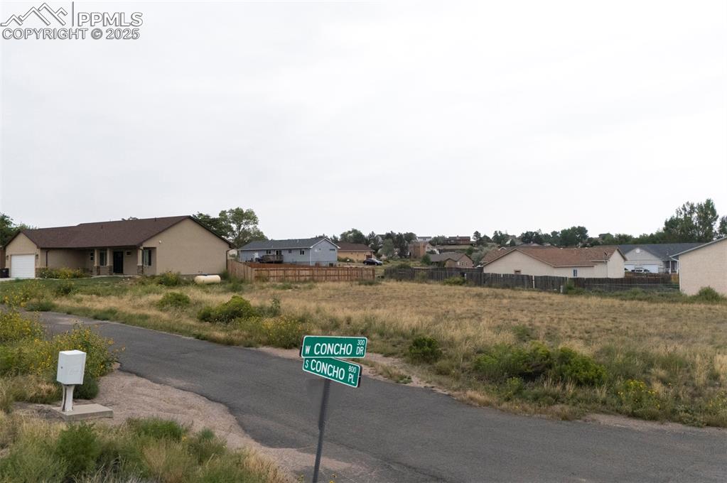 Image 10 of 11: View of asphalt street featuring a residential view