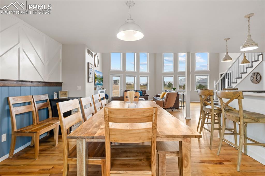 Image 12 of 48: View from dining area looking toward the living room with the large windows