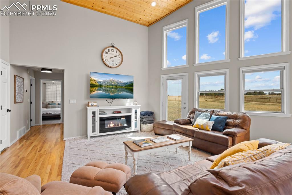 Image 14 of 48: Hallway leads down to two bedrooms and full bathroom and coat closet. 