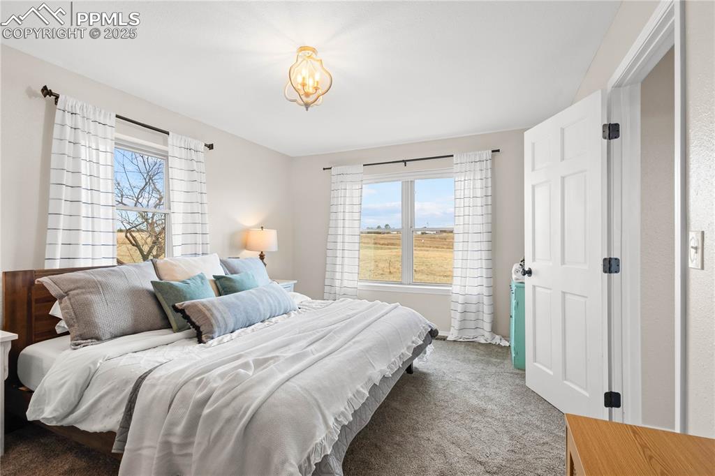 Image 22 of 48: Another view of Bedroom #! showing the windows overlooking the front and si