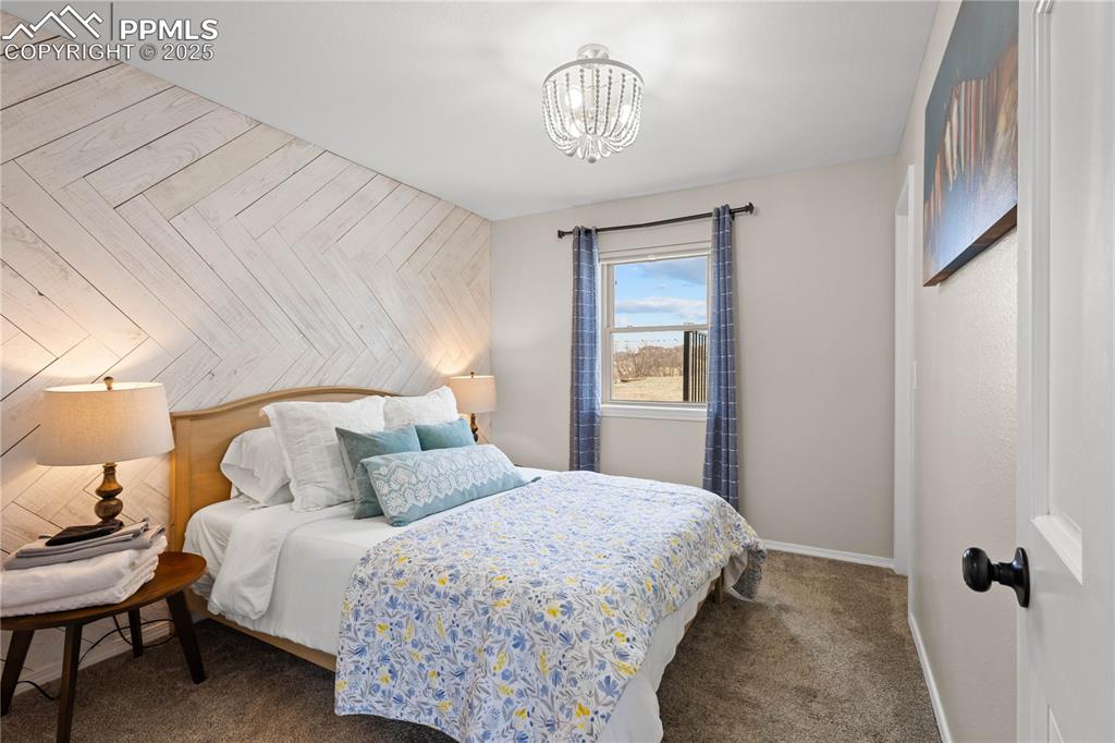 Image 23 of 48: Main level bedroom #2 is located across from the bathroom.