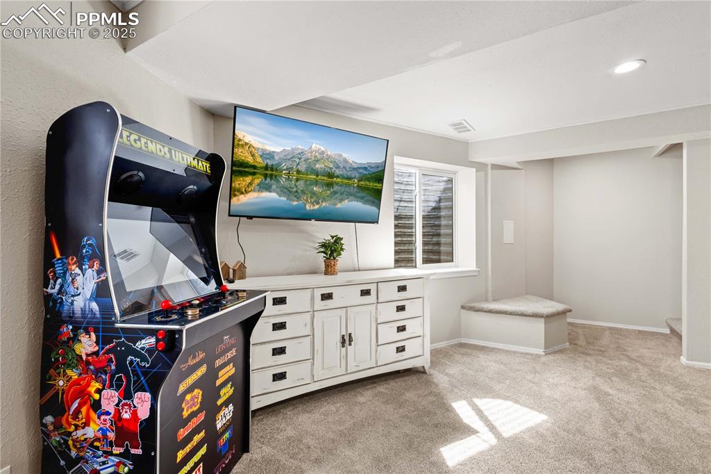 Image 31 of 48: Another view of the family room ...stairs heading upstairs can be seen to t