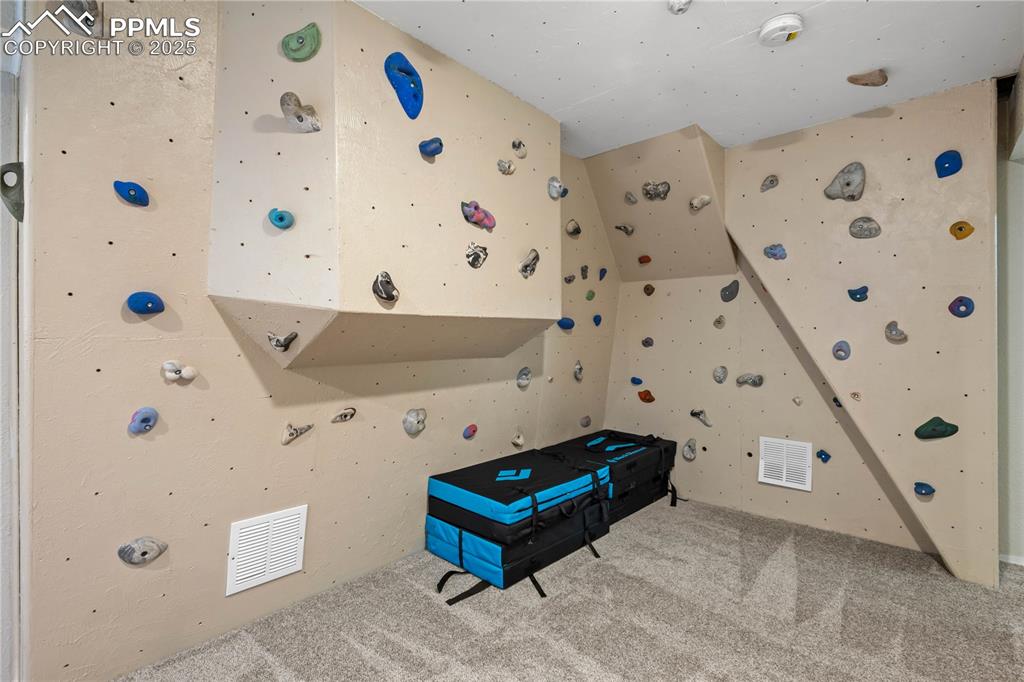 Image 32 of 48: Fun climbing wall in the family room!