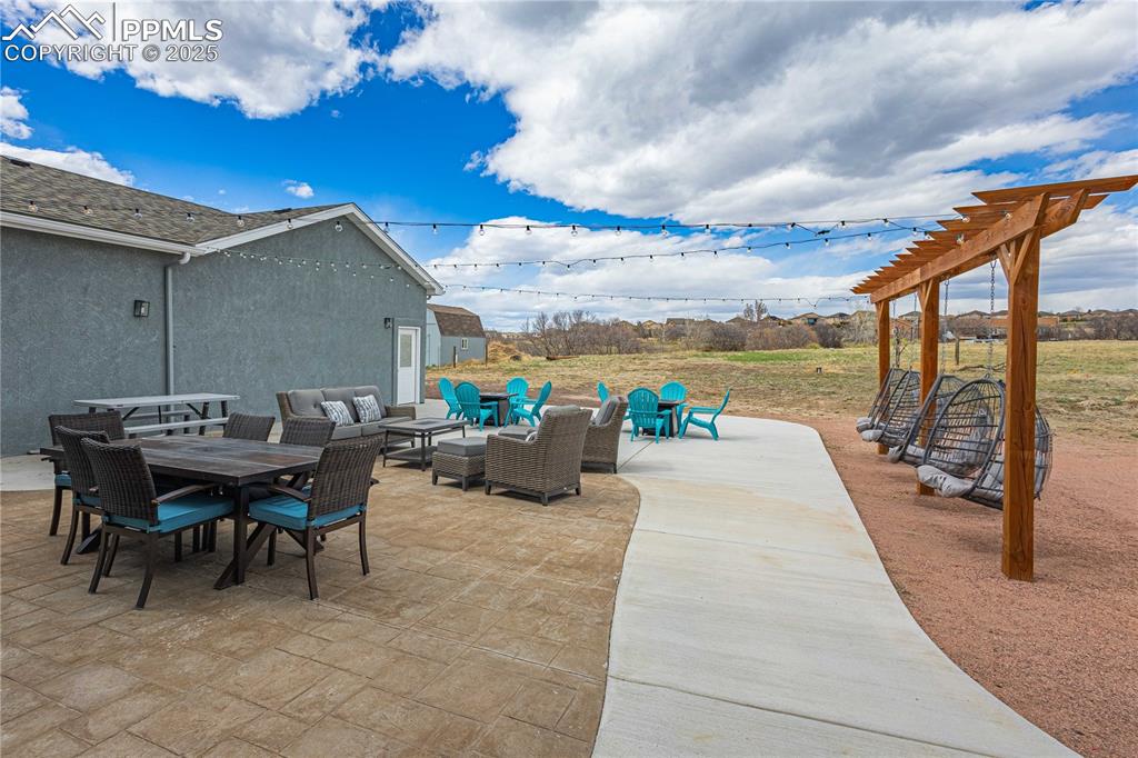 Image 38 of 48: Stamped concrete patio with spacious sidewalk