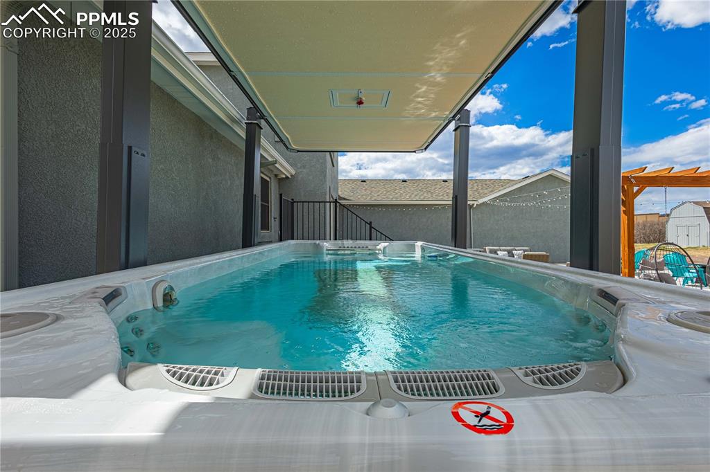 Image 4 of 48: Backyard was made for entertaining with swim pool, swing set and large pati