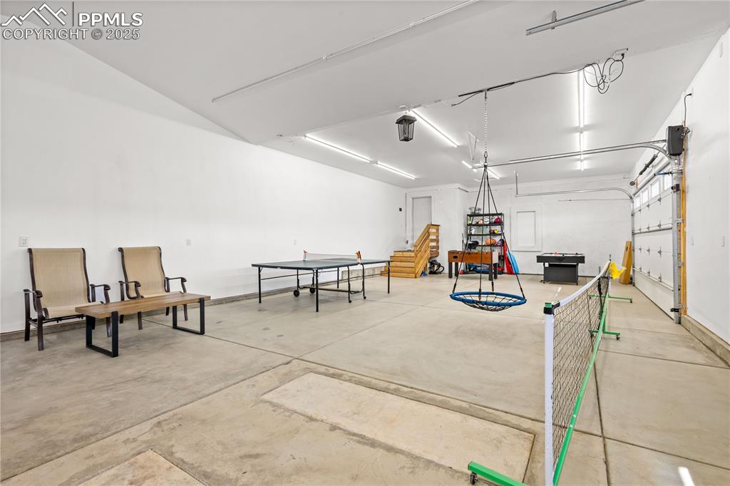 Image 43 of 48: Spacious four car garage has room for vehicles and other storage needs. 