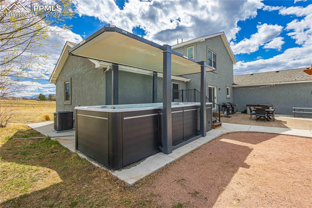 Image 45 of 48: Large swim pool with cover for protection from the sun. 