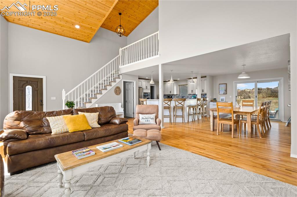 Image 6 of 48: Open main level floor plan features hard wood flooring and walks out from d