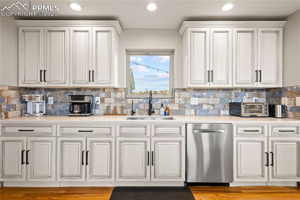 Image 7 of 48: Beautifully remodeled kitchen with window overlooking the backyard.