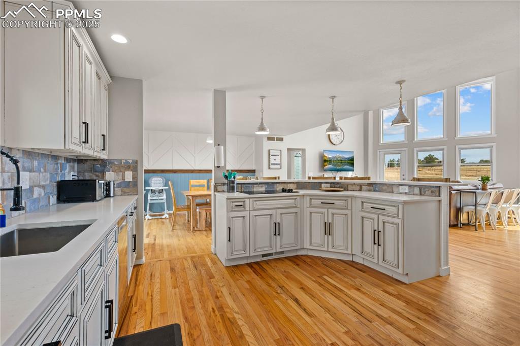 Image 8 of 48: Kitchen has island with cook top and adds additional work space as well as 