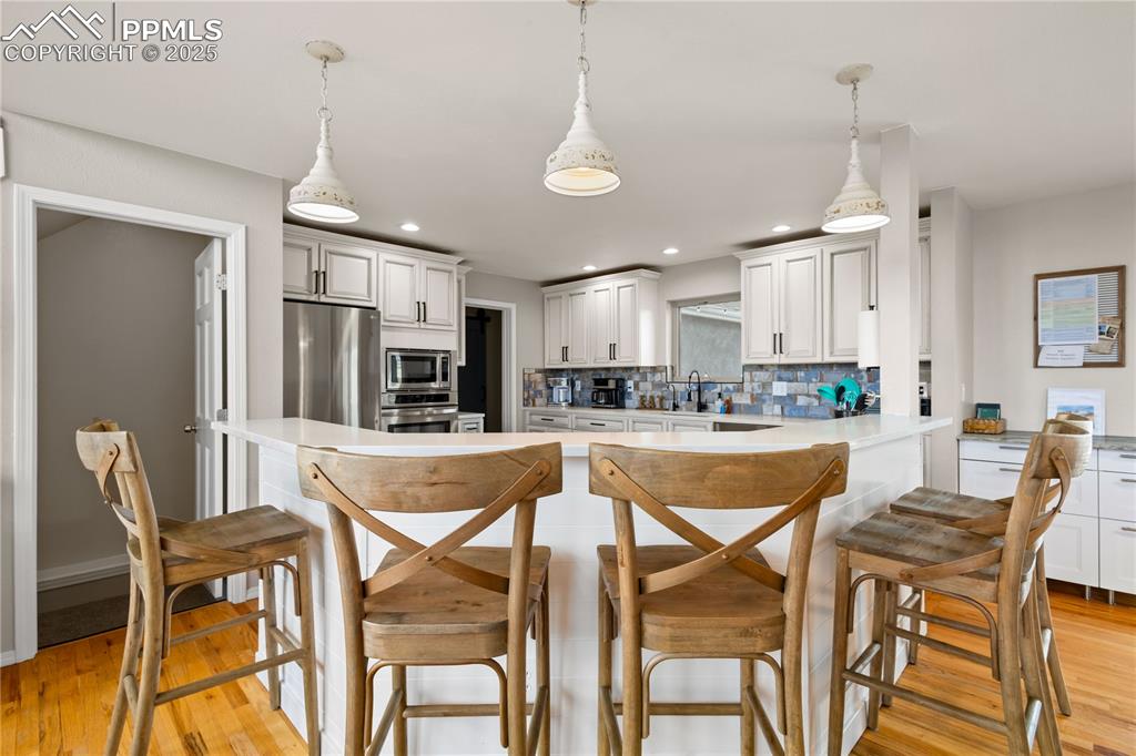 Image 9 of 48: Plenty of space to sit at the counter bar or in the dining room space.