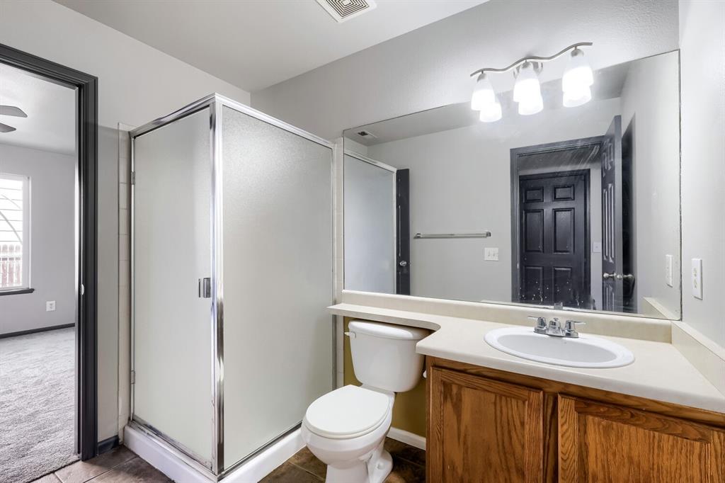 Image 19 of 27: Bathroom featuring a glass-enclosed shower, a vanity with a white oval sink
