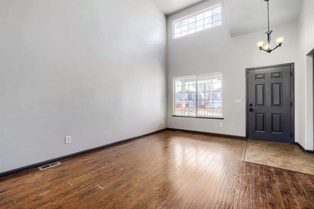 Image 5 of 27: Entryway featuring wood-finish flooring, a two-panel door, and tiled entry