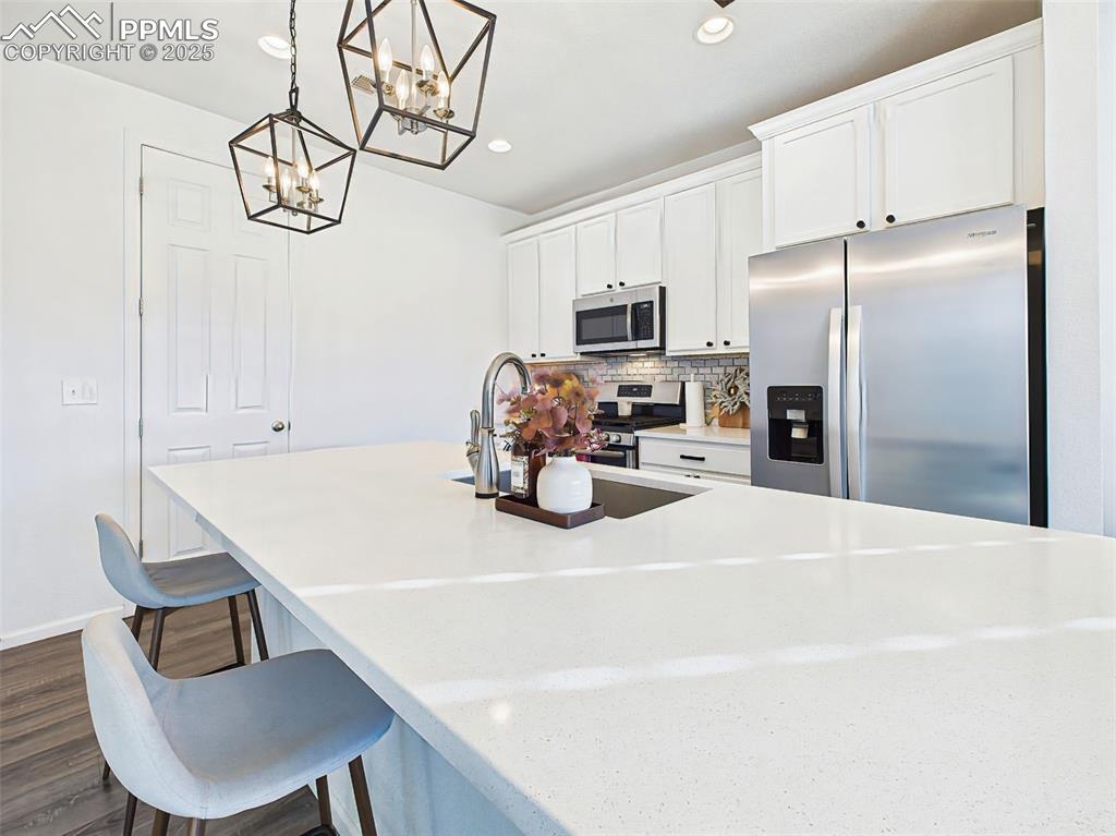 Image 10 of 50: Stylish and functional kitchen featuring Blanco Maple quartz countertops, 4