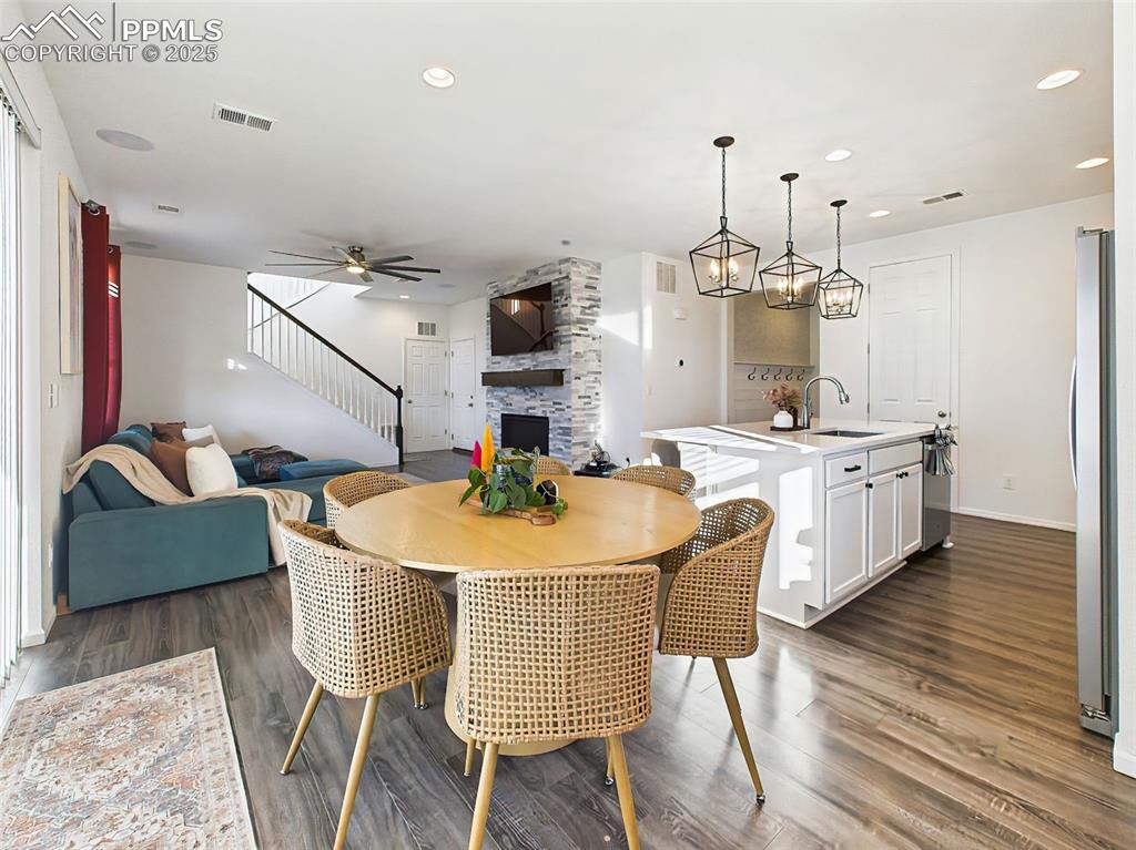 Image 12 of 50: Central dining area seamlessly connects to both the kitchen and great room,