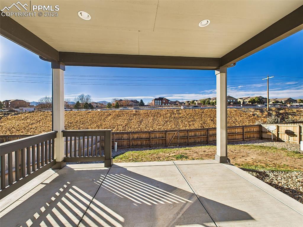 Image 15 of 50: Covered rear patio offers a shaded outdoor living area with Pikes Peak view