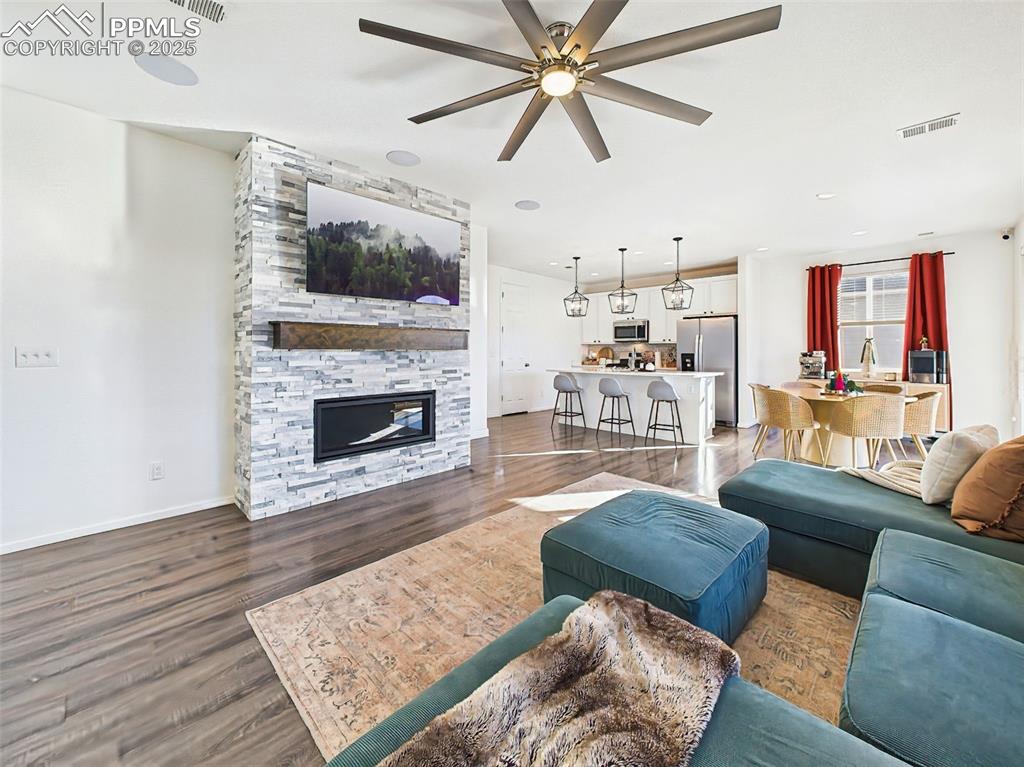 Image 18 of 50: The great room flows effortlessly into the kitchen and dining spaces, with 