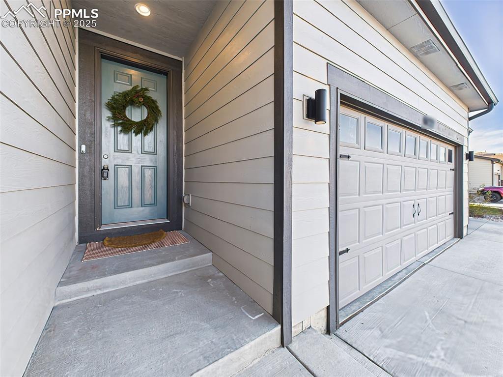 Image 2 of 50: Covered front entry paired with upgraded 3-car garage featuring added windo