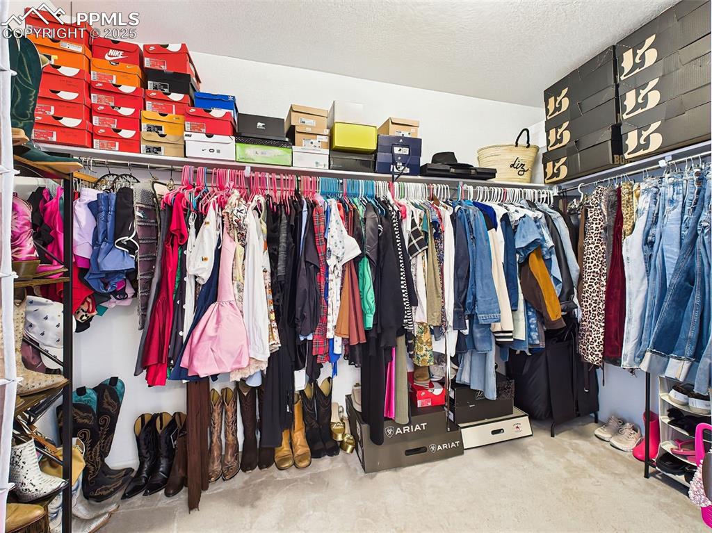 Image 33 of 50: A generous walk-in closet off the primary suite provides ample storage with