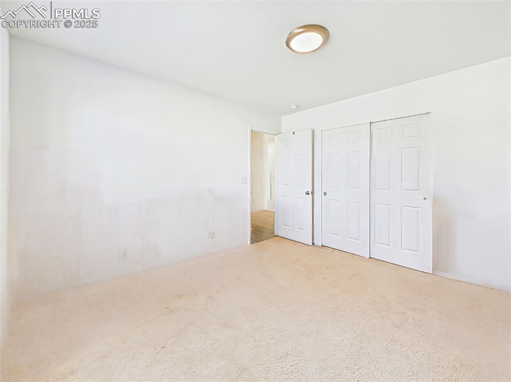 Image 37 of 50: Spacious secondary bedroom with neutral tones, offering a blank canvas for 