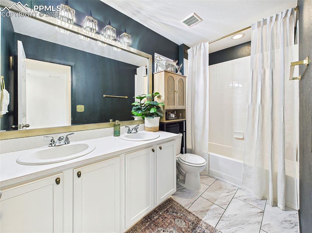 Image 38 of 50: Fully updated upstairs bathroom includes white double vanity, dramatic dark