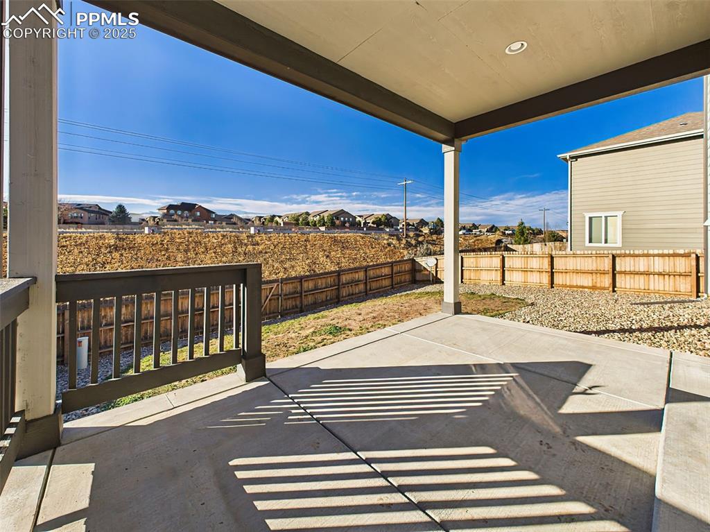 Image 46 of 50: Enjoy shaded outdoor living under the upgraded covered patio—ideal for gril