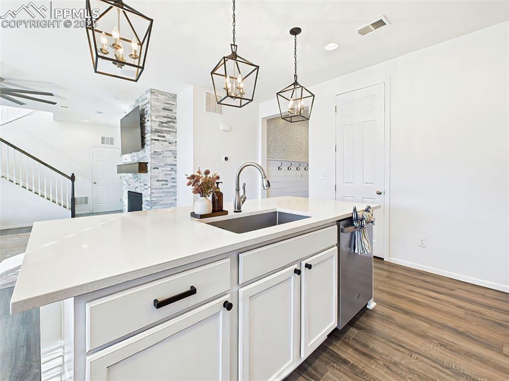 Image 8 of 50: A spacious island with pendant lighting, undermount sink, and pull-down Tou