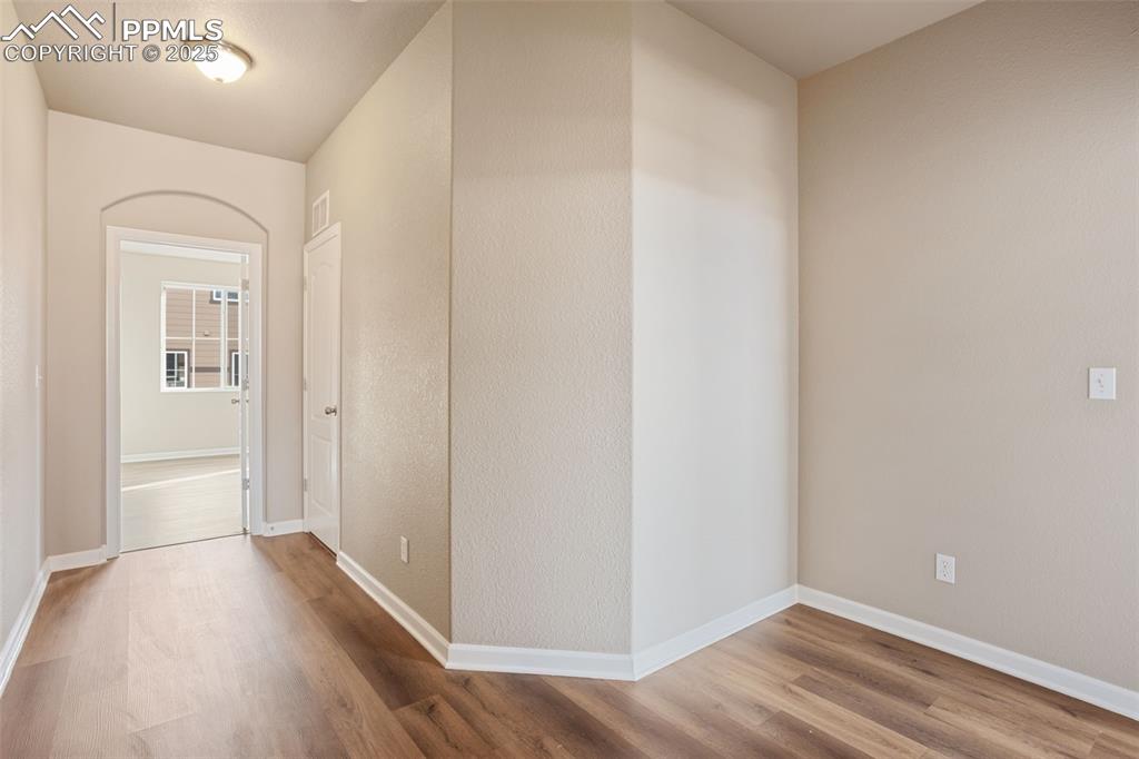 Image 13 of 30: Upper hallway, going toward laundry and primary bedroom.