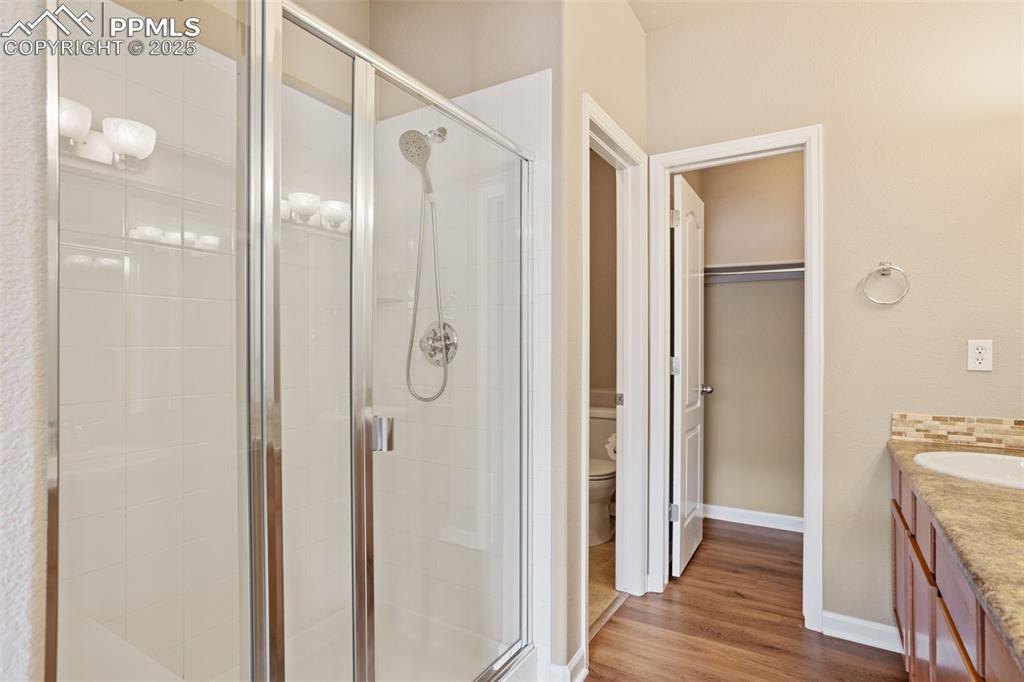 Image 17 of 30: Large walk-in shower with seat.