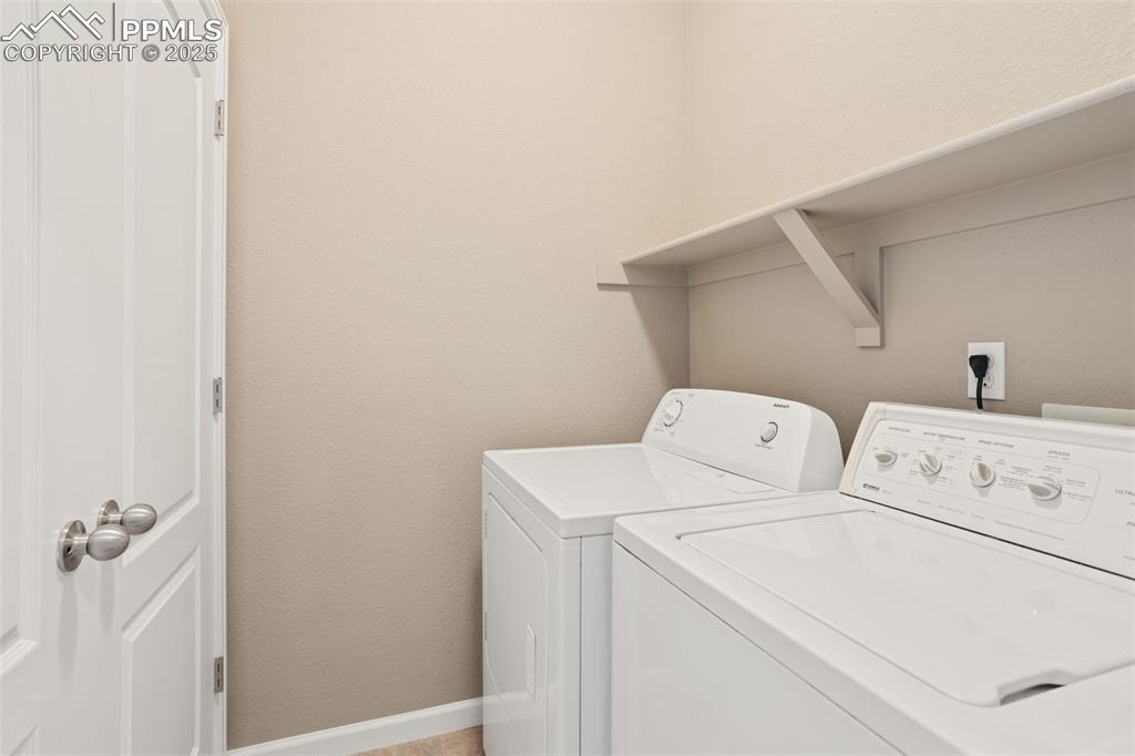Image 19 of 30: Upper laundry area; appliances included.