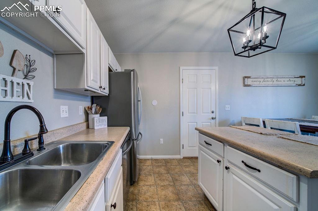 Image 16 of 48: The Kitchen features a dual stainless steel sink.