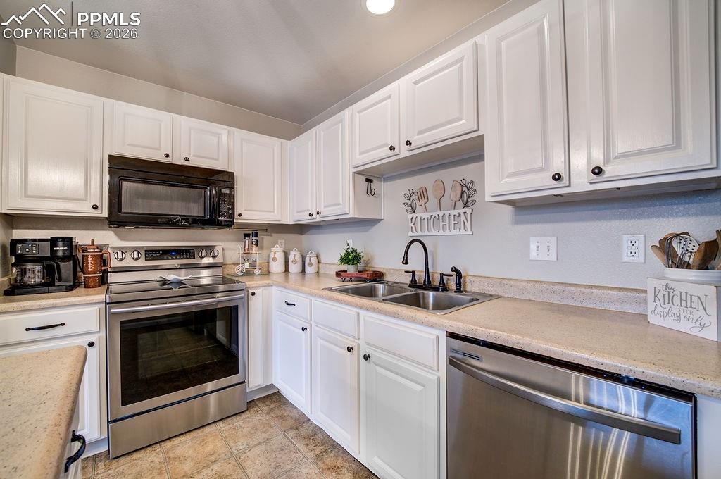 Image 17 of 48: Stainless steel appliances include a smooth top range oven, built in microw