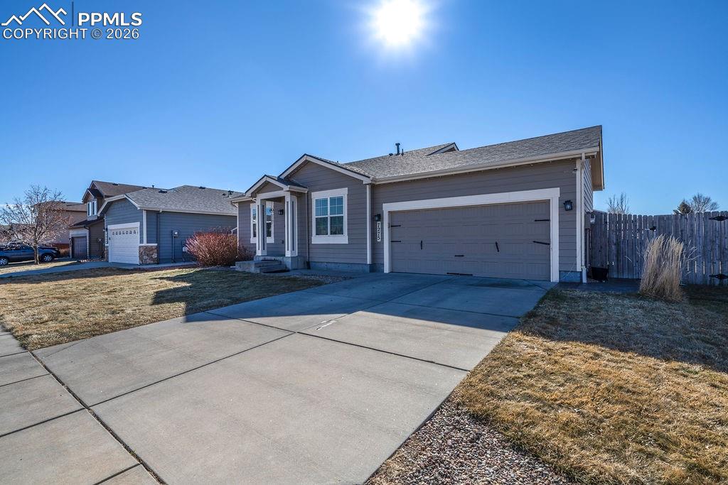 Image 2 of 48: Low maintenance landscaping with a 2-car attached garage.