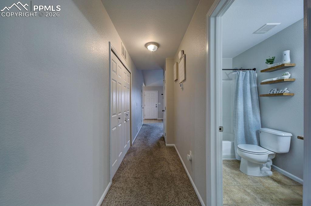 Image 24 of 48: View into the Hall Bathroom and Laundry Closet.