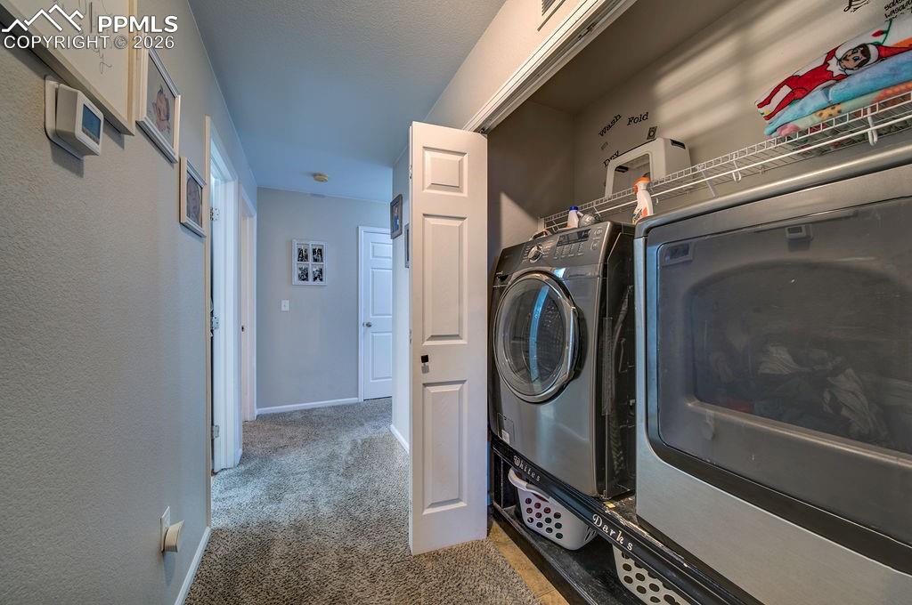 Image 25 of 48: Laundry closet with washer and dryer that stay.
