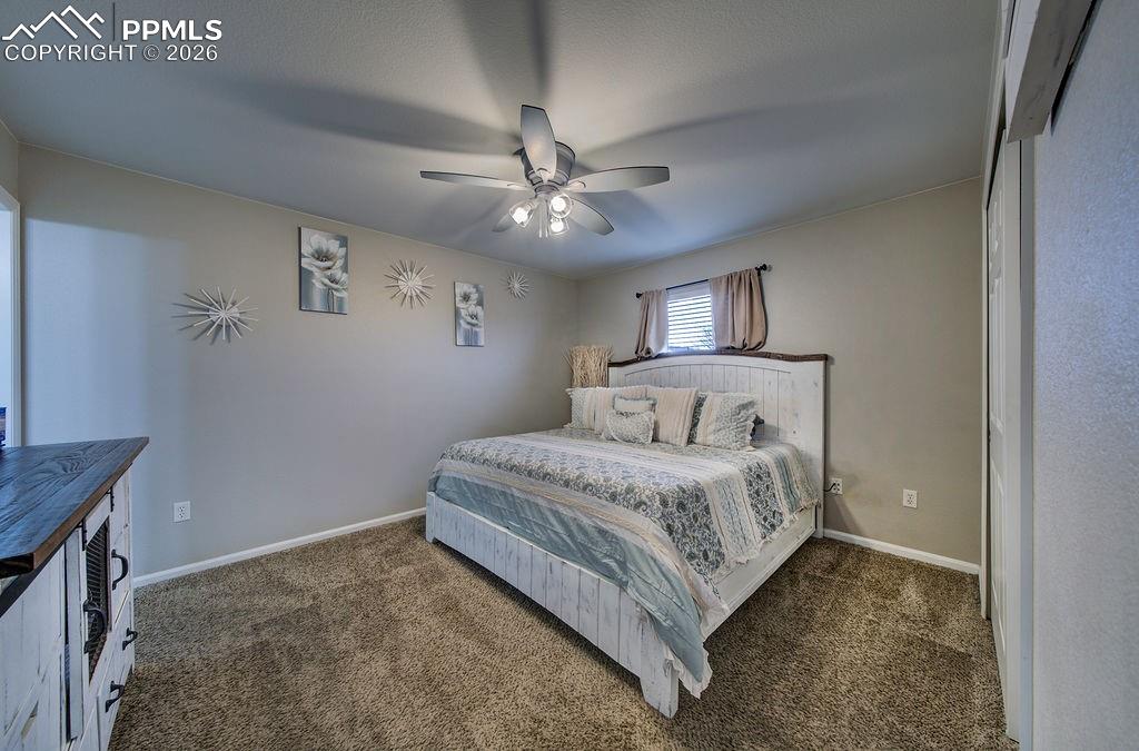 Image 26 of 48: The Primary Bedroom is a private retreat with neutral carpet, a lighted cei