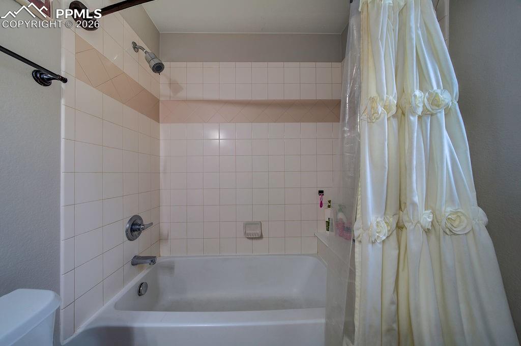 Image 31 of 48: Tiled tub/shower in the Primary Bathroom.